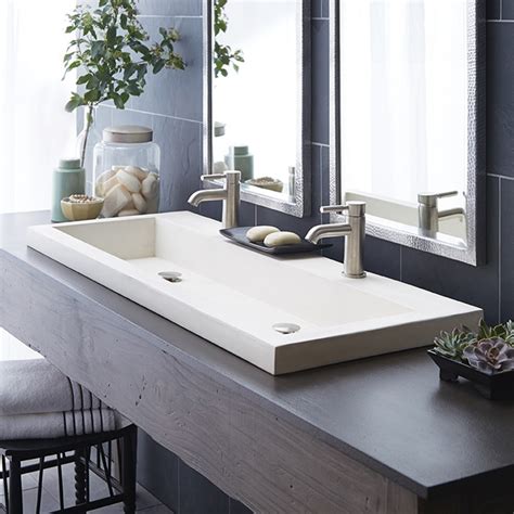 This view shows the overall floating vanity which is 96 inches 8 ft in width. . Double faucet trough sink